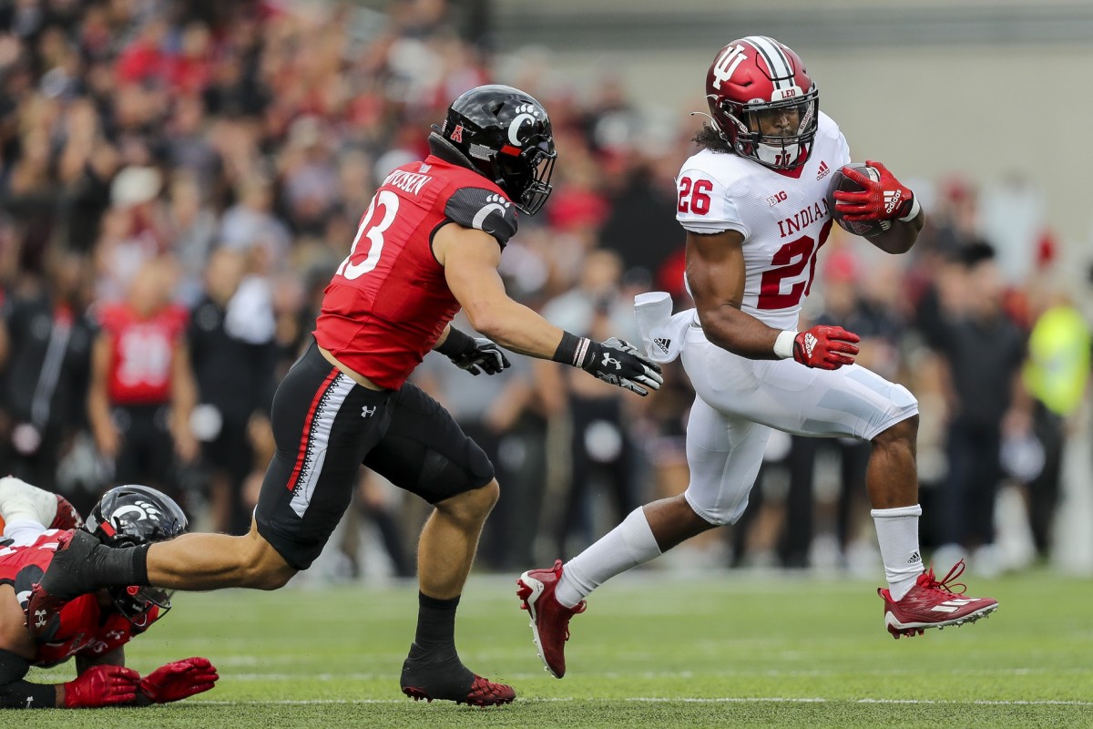 Indiana Hoosiers running back Josh Henderson (26) runs with the ball against Cincinnati Bearcats linebacker Ty Van Fossen (13) in the first half at Nippert Stadium.